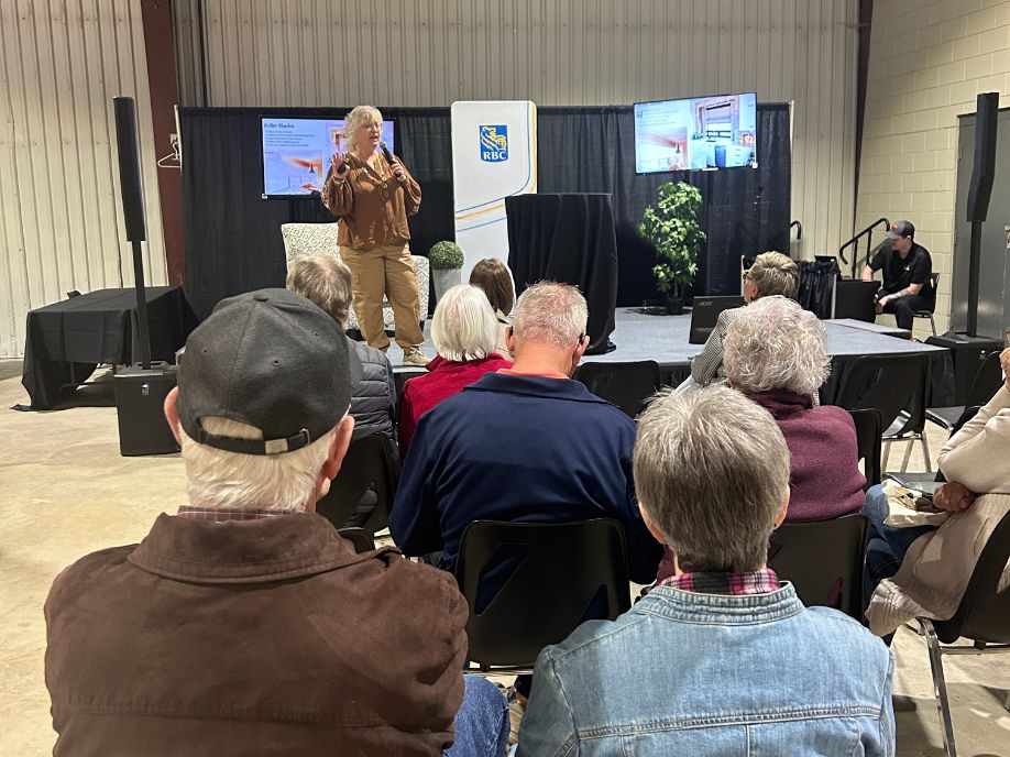 A man in a cowboy hat and a woman look at a display of garden tractors / mowers at the Brandon Home & Leisure Show