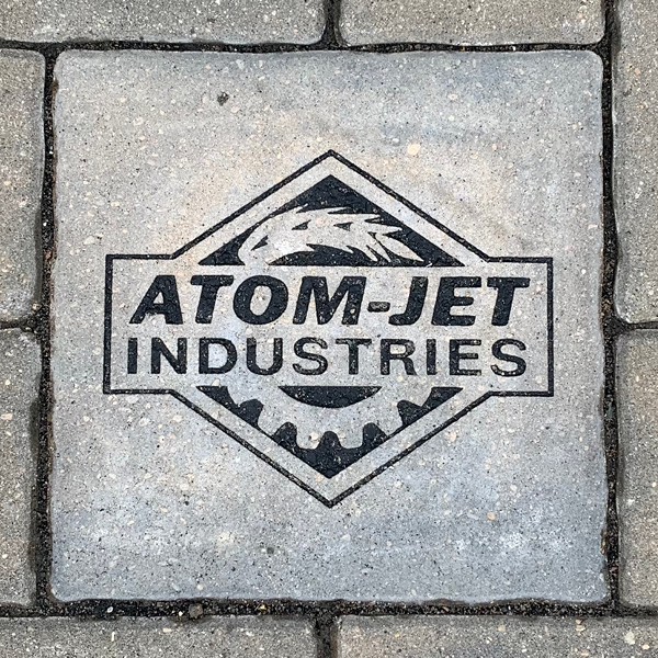 An image of a paving stone engraved with the name of a local business. The stones appear in the walkway at The Dome Building at the Provincial Exhibition of Manitoba.
