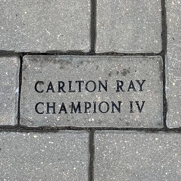 An image of a paving stone engraved with a name. The stones appear in the walkway at The Dome Building at the Provincial Exhibition of Manitoba.